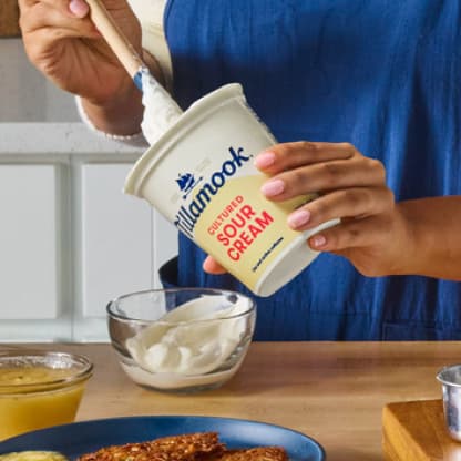 Person scooping Tillamook Sour Cream
